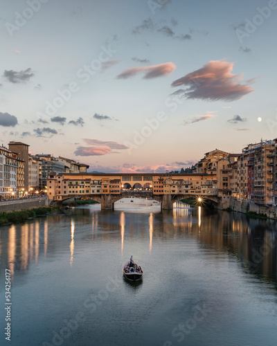View of Ponte Vecchio bridge crossing the Arno river in Florence downtown, Tuscany, Italy. photo