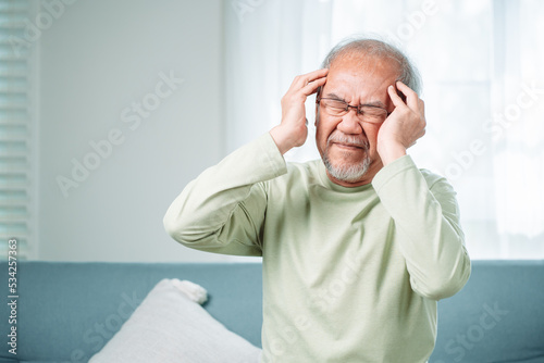 Wallpaper Mural Closeup of Asian Senior elderly old man feel headache suffering and migraine in living room at home. Stressed mature male hurt mental health care and insurance concept. Torontodigital.ca