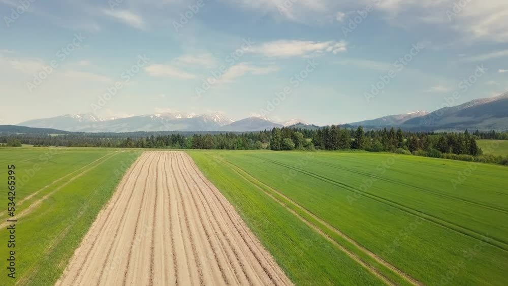 Aerial view of plowed field in green rural country in fresh spring nature farm farmland Aerial view of plowed field in green rural country in fresh spring nature farm farmland