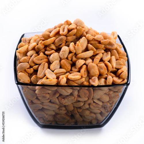 pile of spiced peanuts isolated close up on white background 