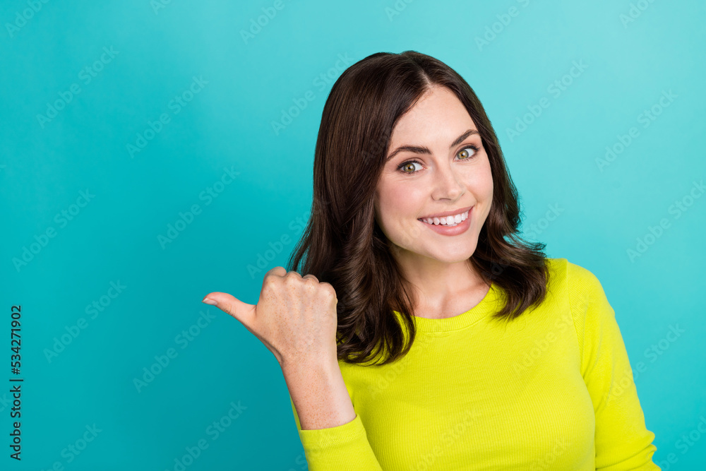 Fototapeta premium Closeup photo of young pretty attractive girlish lady finger directing empty space promo new shopping mall isolated on cyan color background