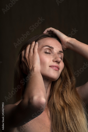 portrait of a young attractive woman on a dark background