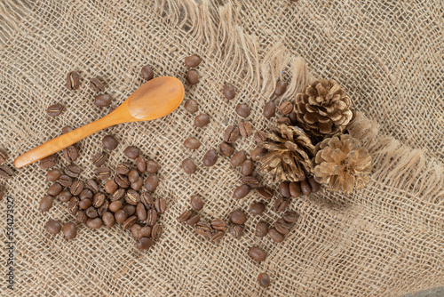 Pinecones, coffee beans and spoon on burlap