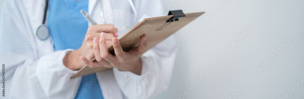 Hand of doctor holding patient clipboard with copy space for adding text or advertising. Medical healthcare career