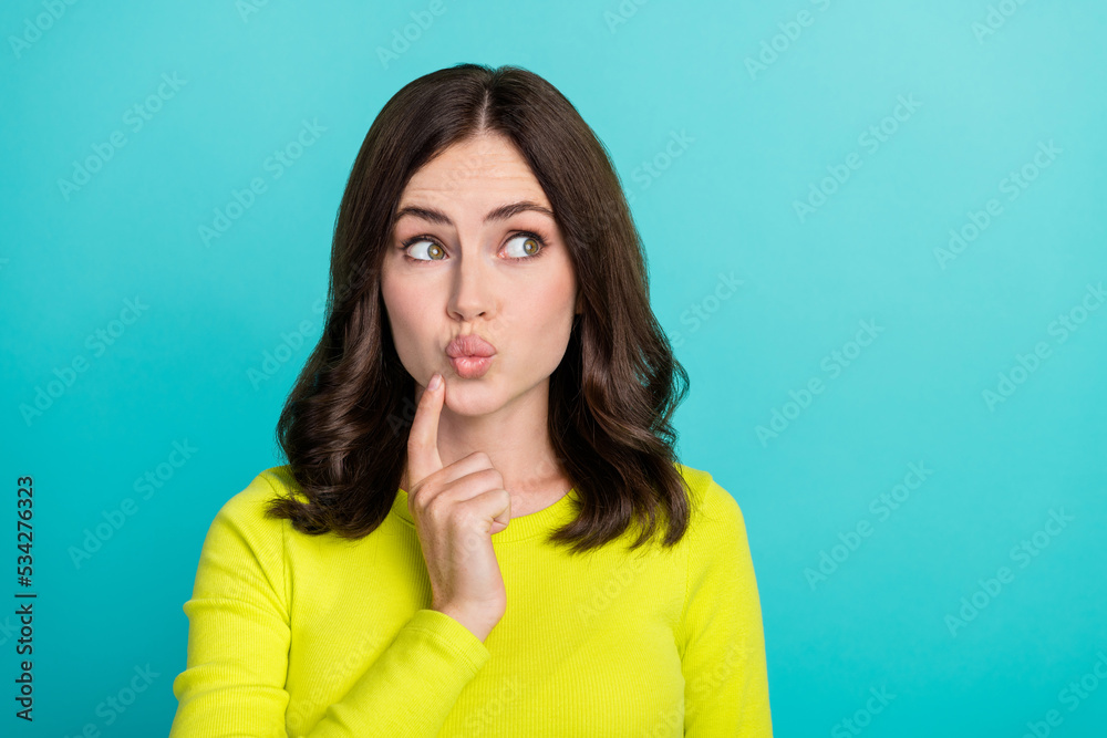 Photo of thinking brunette hair young lady look promo wear yellow shirt isolated on teal color background Photo of thinking brunette hair young lady look promo wear yellow shirt isolated on teal color background