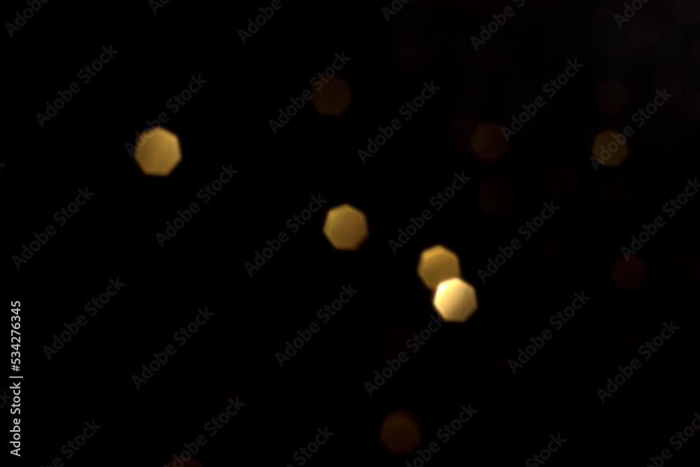 Golden blurred bokeh lights on black background. Glitter sparkle stars for celebrate. Overlay for your design Golden blurred bokeh lights on black background. Glitter sparkle stars for celebrate. Overlay for your design
