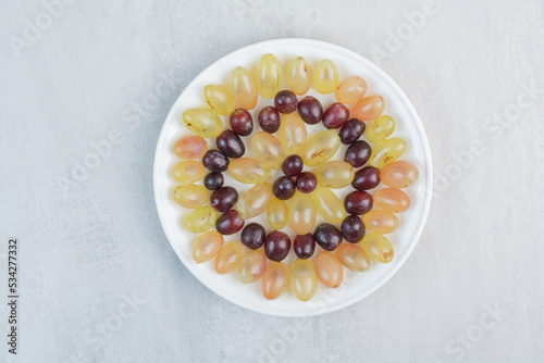 Fresh grapes plate on stone background