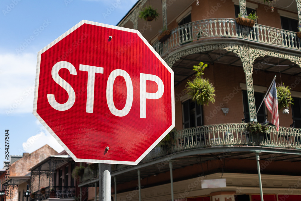 Stop Sign along a Street in the French Quarter of New Orleans with Old Buildings in the Background Stop Sign along a Street in the French Quarter of New Orleans with Old Buildings in the Background
