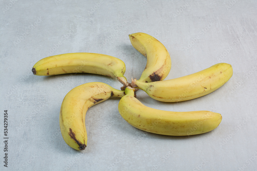 Bunch of yellow bananas on stone background Bunch of yellow bananas on stone background