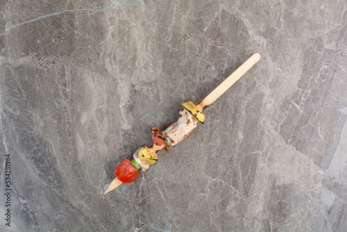 Fried vegetables with chicken meat on wooden stick