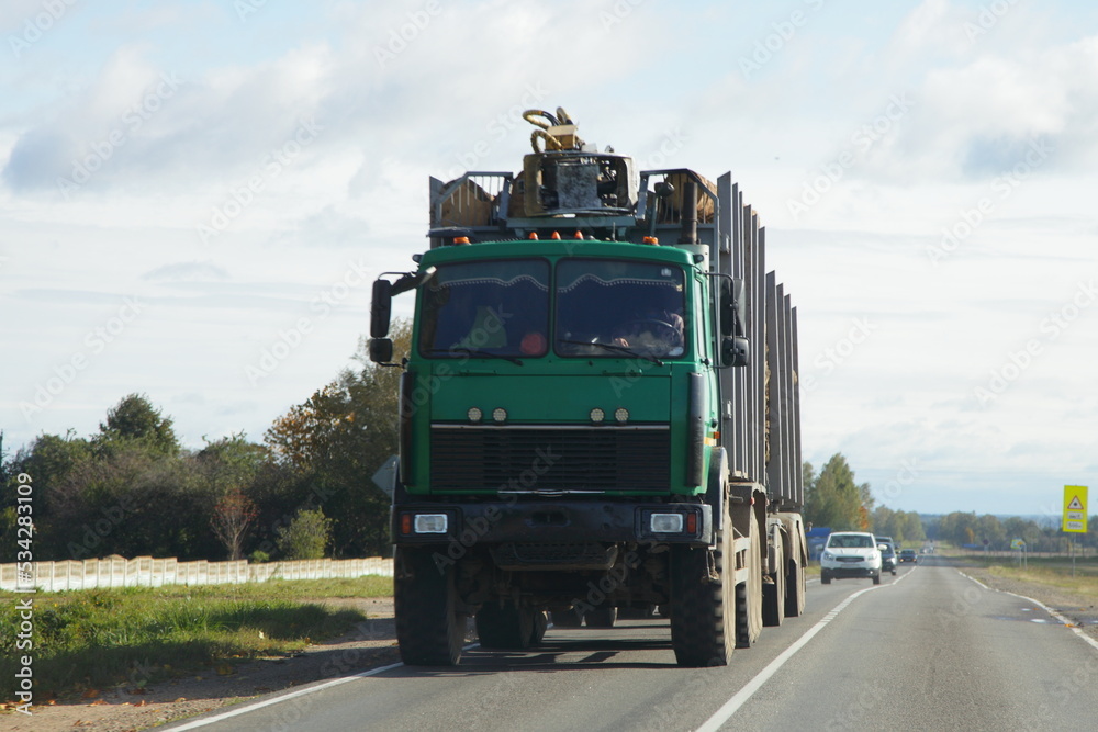 Heavy loaded timber truck with trailer on the road