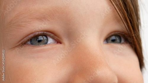 Close-up of beautiful childs eyes looking into the distance