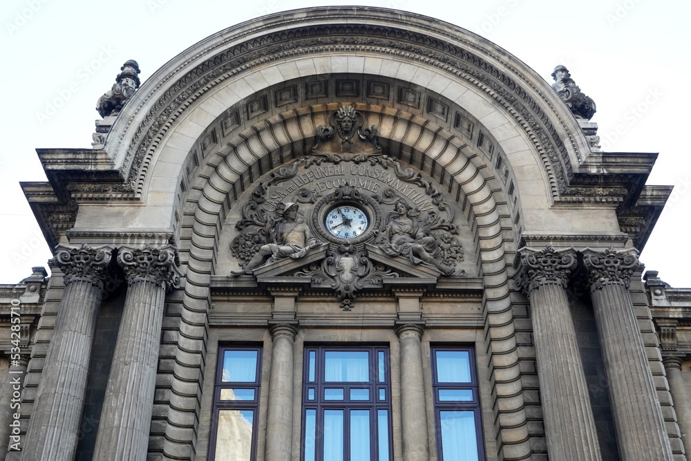 Architectural details of CEC Palace facade on Calea Victoriei boulevard in center of Bucharest. Semicircular pediment with stone sculpture depicting Mercury and Demetra deities
 - obrazy, fototapety, plakaty 