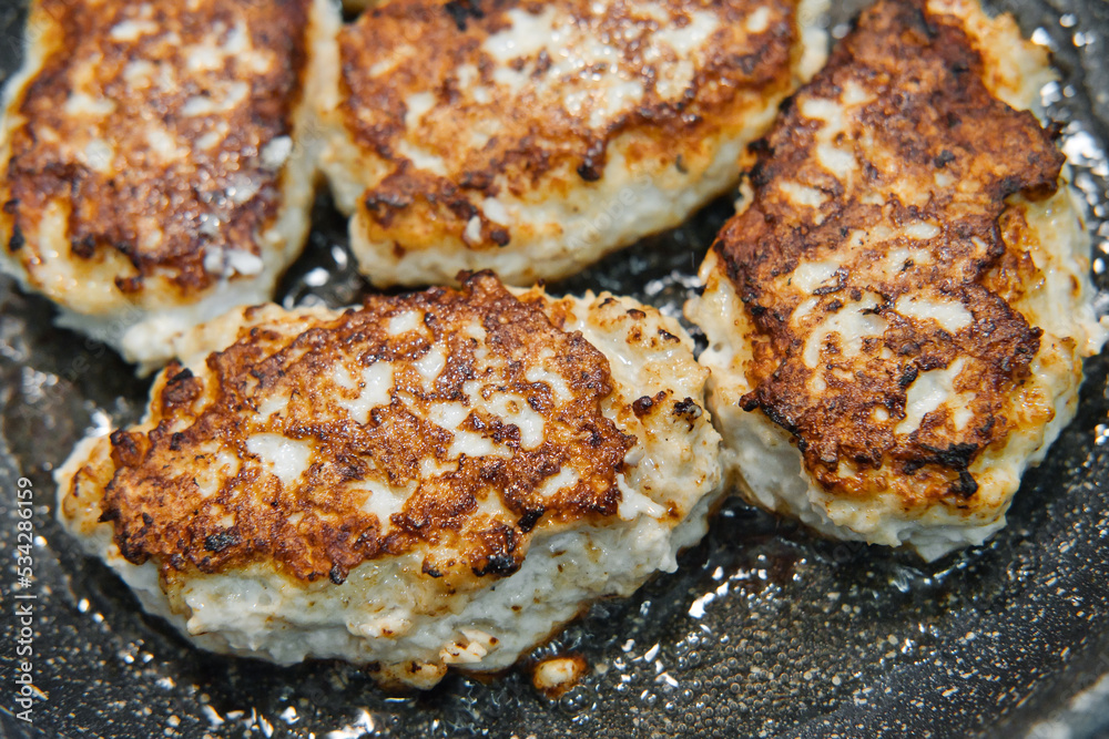 Frying rissoles in a pan close-up. Cooking rissoles with fried crust.