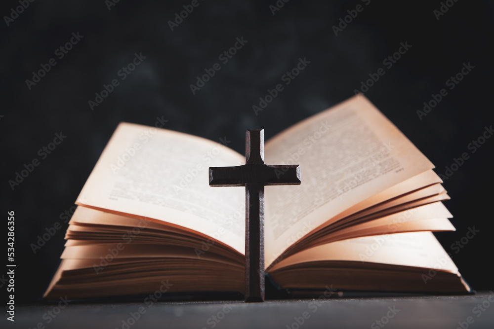 open book and cross on the table open book and cross on the table