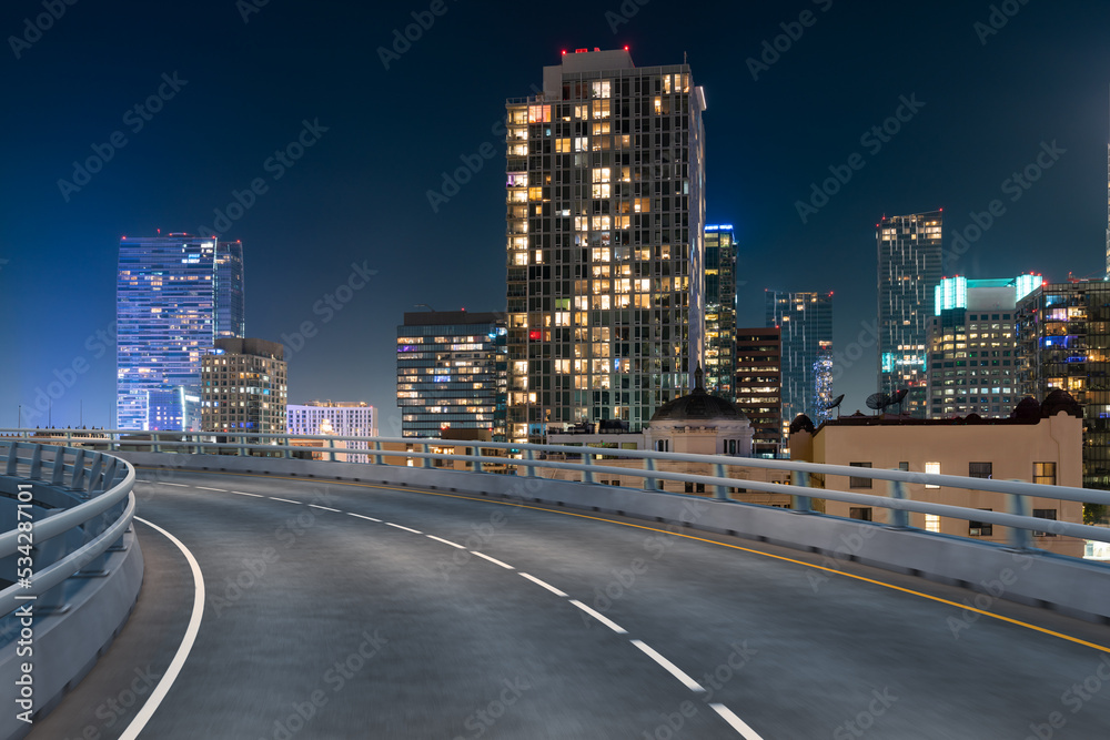 Naklejka premium Empty urban asphalt road exterior with city buildings background. New modern highway concrete construction. Concept of way to success. Transportation logistic industry fast delivery. Los Angeles. USA.