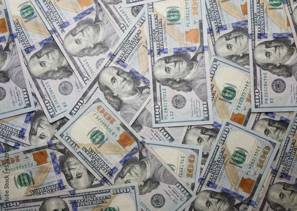 A pile of new $100.00 USD bills or bank notes. A pile of new $100.00 USD bills or bank notes.