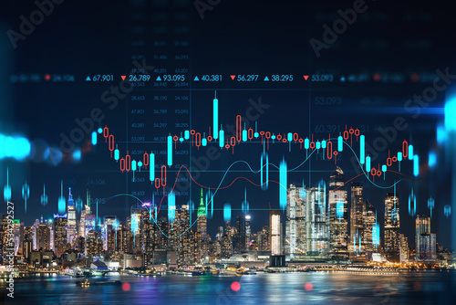 New York City skyline from New Jersey over the Hudson River with Hudson Yards at night. Manhattan, Midtown. Forex candlestick graph hologram. The concept of internet trading, brokerage, analysis