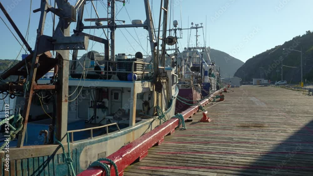 A row of commercial fishing trawlers tied up in St. John's Harbour A row of commercial fishing trawlers tied up in St. John's Harbour