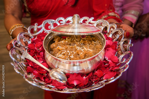 Moong dal halwa is a classic Indian sweet dish made with moong lentils, sugar, ghee(clarified butter). Sweet dessert pudding from India. Garnished with almond nuts photo