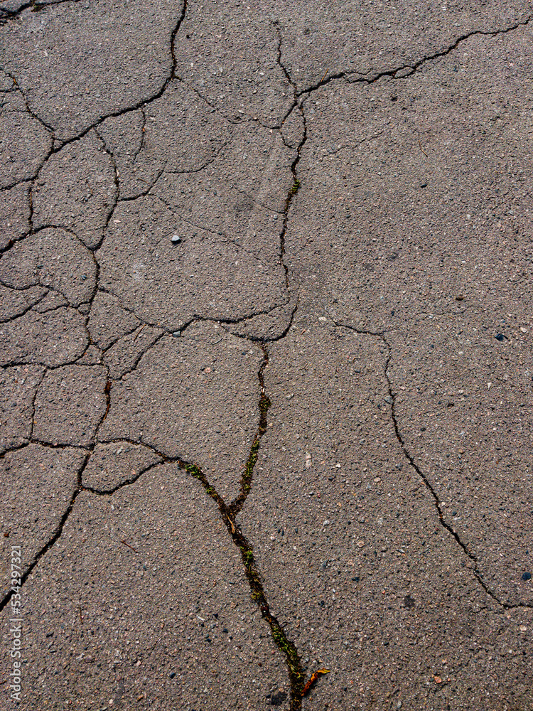 Obraz premium cracks in the asphalt