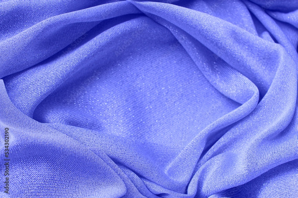Fototapeta premium Light purple shiny fabric, folded in folds. Shiny knitwear, organza. Solid background.