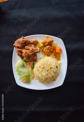 Fried rice with chicken fry and curry. Thai rice with veg and chicken crispy with masala.