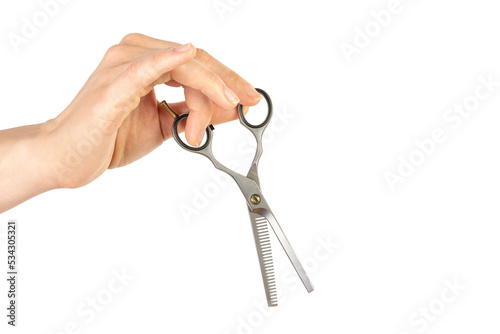 Female hand holds thinning scissors. Isolated on white background