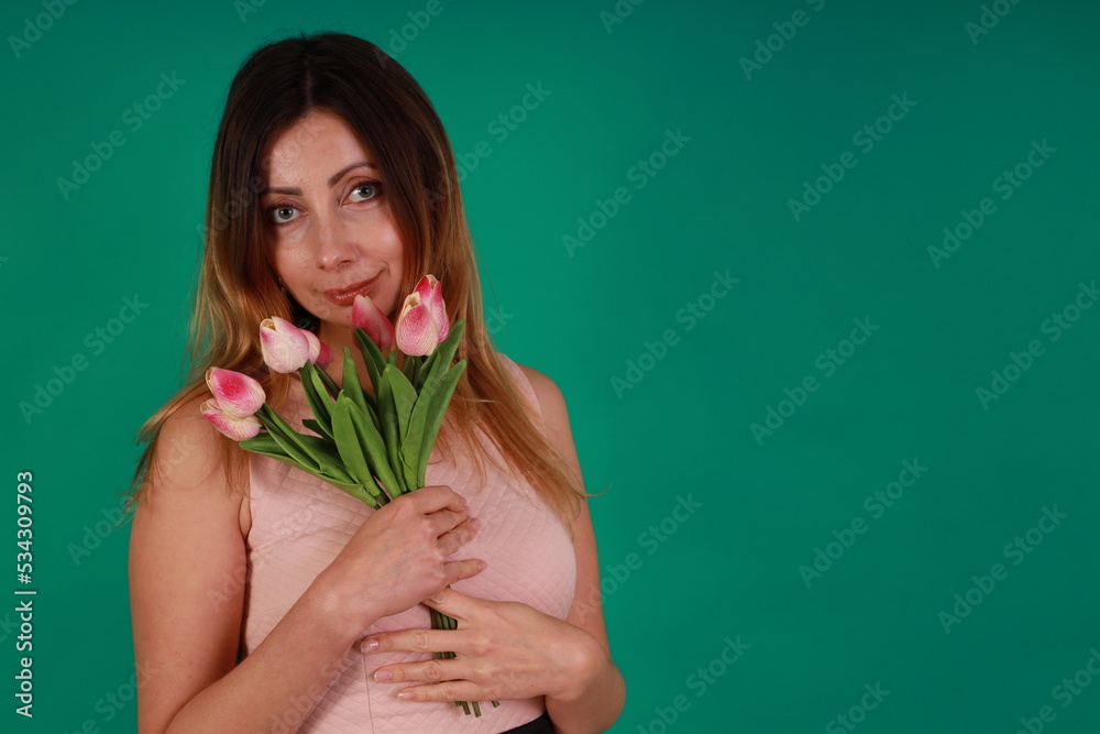 Pretty woman with tulips on green background Pretty woman with tulips on green background
