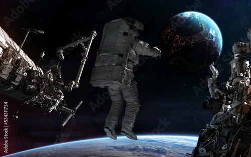 Astronaut, orbiting space stations and planets in deep space. Science fiction. Elements of this image furnished by NASA