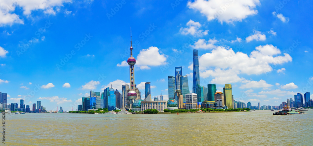 View of the skyline along the riverside on a sunny day in Shanghai, China.