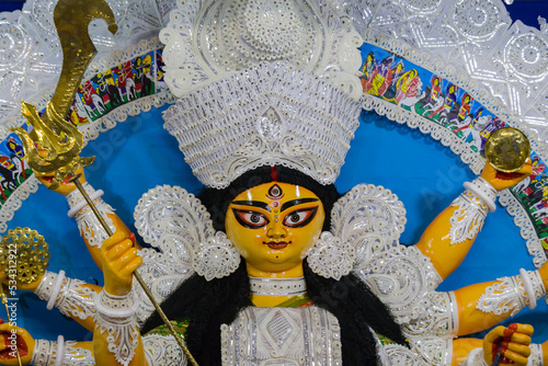idol of goddess Durga during Durga Puja festival. Hindu deity in traditional white daker saj decorated attire. Durga puja is unesco approved heritage cultural festival in west bengal india.