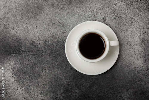 Cup of coffee on a dark background. Hot fragrant coffee on a textural background. Place for copy space.Place for text. Flat lay.