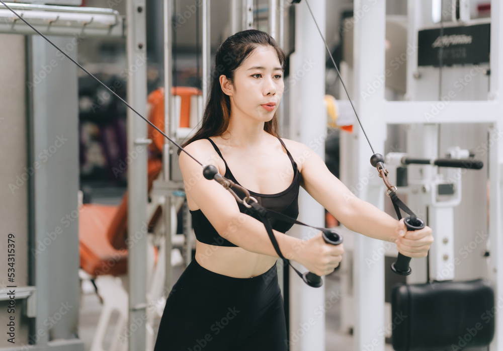 Asian female fitness athlete in gym