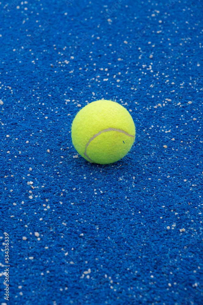 selective focus on a tennis ball on a blue paddle tennis court, racket sports