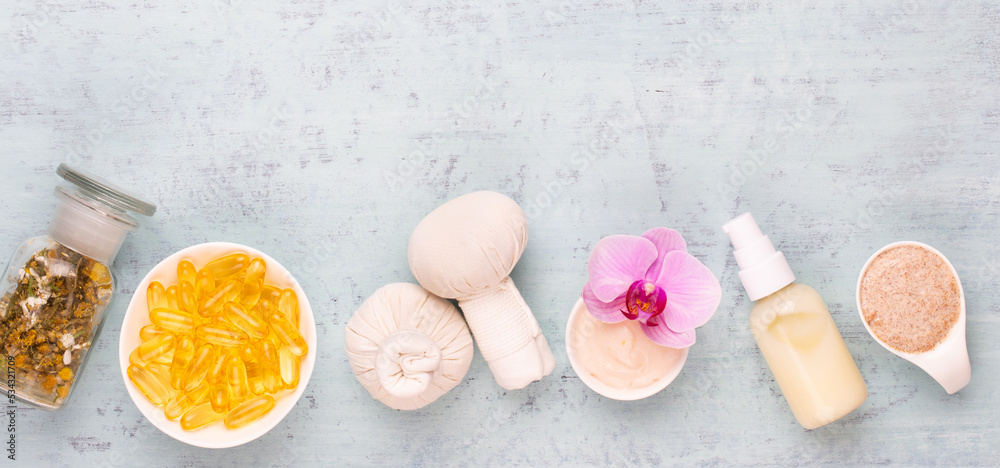 Sea salt, aromatherapy oil in bottles and orchid on vintage wooden background. Sea salt, aromatherapy oil in bottles and orchid on vintage wooden background.