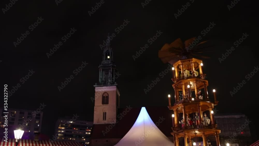 During the Christmas market in Berlin, Germany, a beautiful wooden toy carousel is spinning, the concept of trade and entertainment combined. During the Christmas market in Berlin, Germany, a beautiful wooden toy carousel is spinning, the concept of trade and entertainment combined.