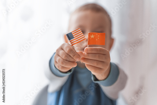 Photography Kid showing Usa and china national flag