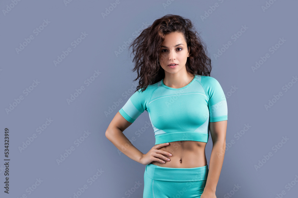 fitness woman in sportswear at studio with copy space. fitness woman in sportswear - obrazy, fototapety, plakaty 