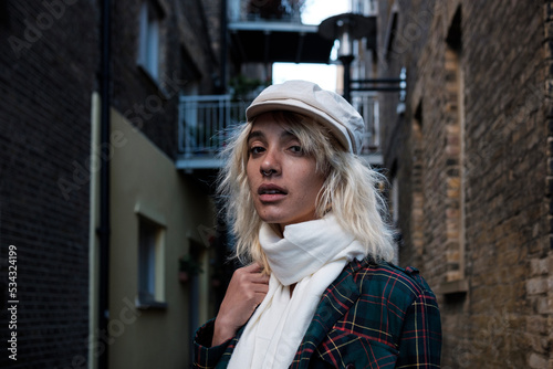 Head shot of alternative beautiful woman model looking at camera in a narrow street. © Jorge Elizaquibel