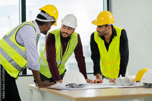 A team of male engineers and architects worked together in a conference room  discussing design and construction. Construction planning. Engineer working as a team. teamwork. Construction concept.