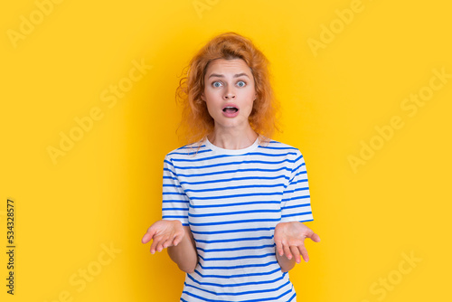 amazed redhead woman portrait isolated on yellow background. portrait of young redhead woman