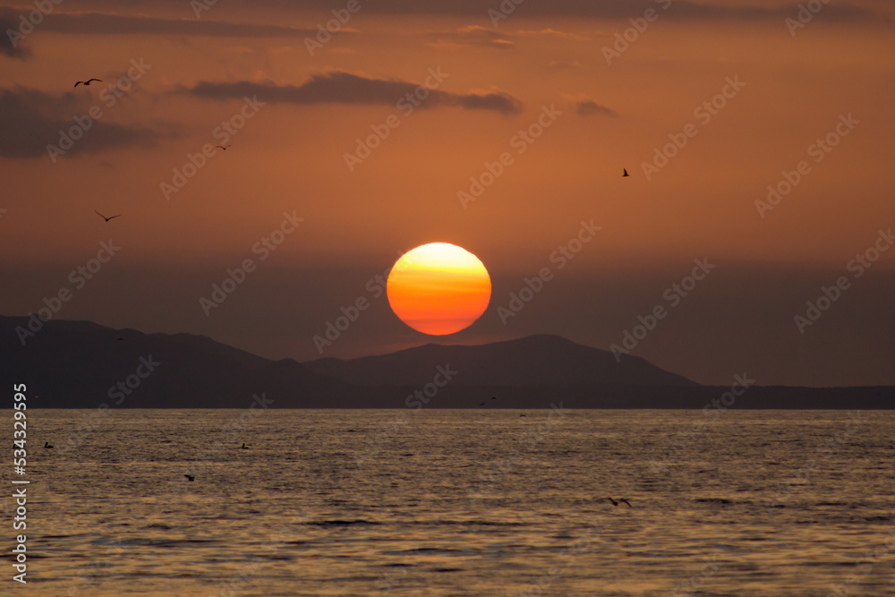 Egg Yolk Sunset on the sea in Margarita Island - Venezuela. Beach sunset, golden hour. Twilight