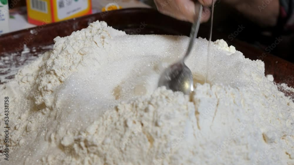 Adding granulated sugar and vegetable oil to flour for baking homemade ...