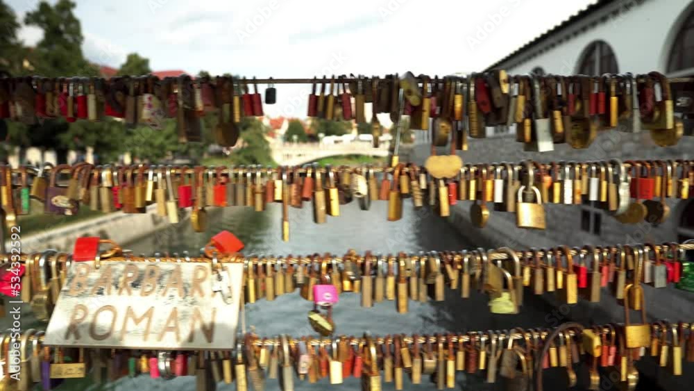 Butcher's Bridge in Ljubljana. Pedestrian bridge over the river Ljubljana in Ljubljana. Bridge of lovers in Ljubljana. Locks of lovers along the railing as a sign of love and fidelity to each other. Butcher's Bridge in Ljubljana. Pedestrian bridge over the river Ljubljana in Ljubljana. Bridge of lovers in Ljubljana. Locks of lovers along the railing as a sign of love and fidelity to each other.