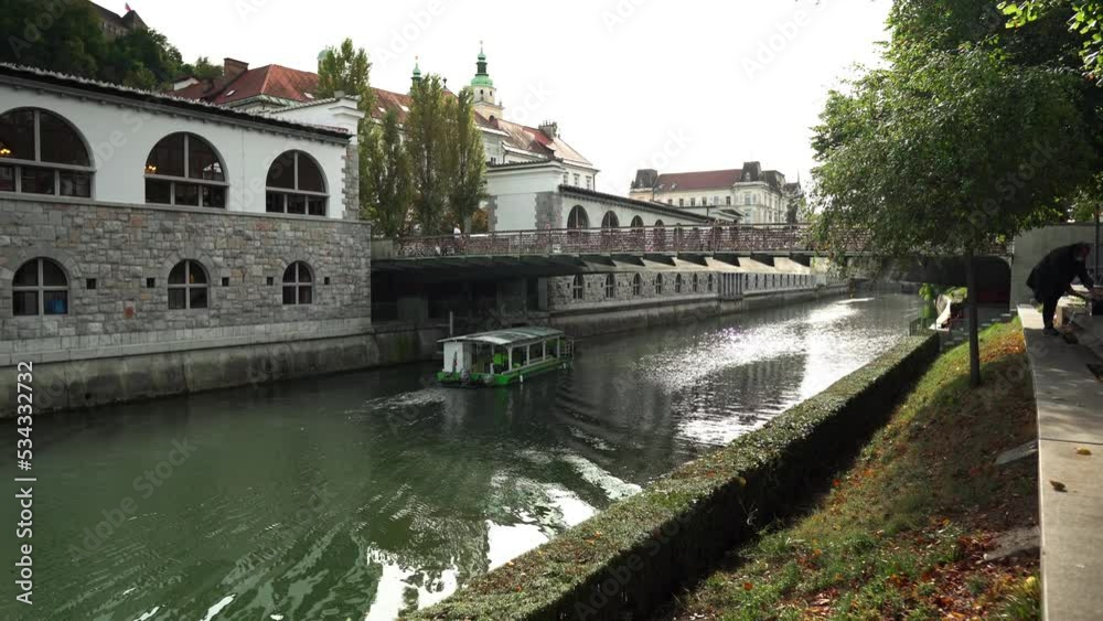 Butcher's Bridge in Ljubljana. Pedestrian bridge over the river Ljubljana in Ljubljana. Bridge of lovers in Ljubljana. Locks of lovers along the railing as a sign of love and fidelity to each other. Butcher's Bridge in Ljubljana. Pedestrian bridge over the river Ljubljana in Ljubljana. Bridge of lovers in Ljubljana. Locks of lovers along the railing as a sign of love and fidelity to each other.