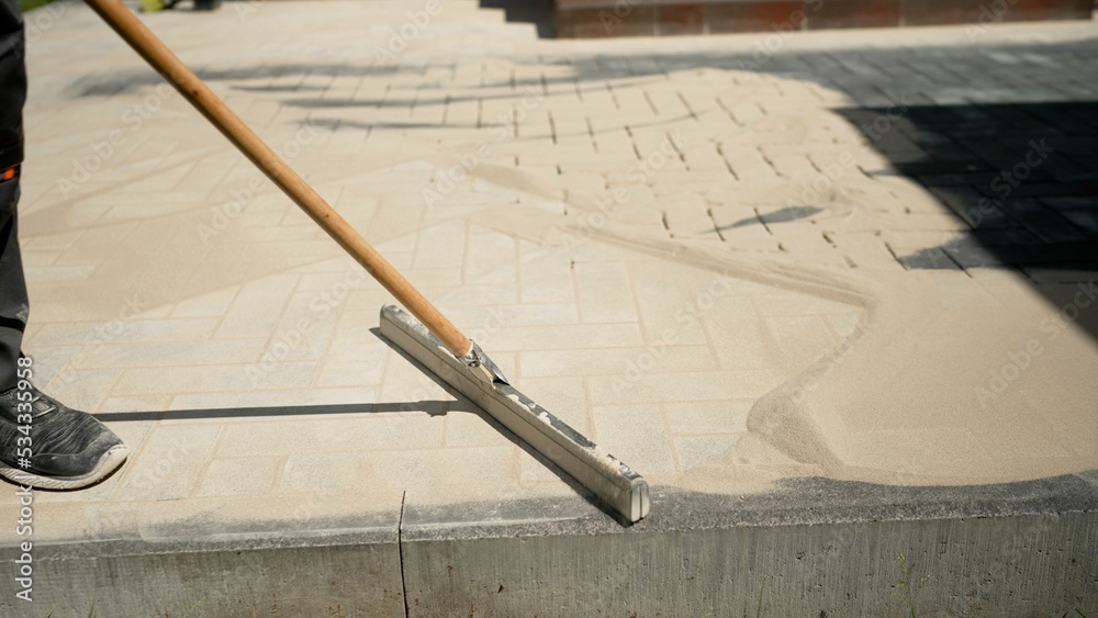 Closeup of sand on a new pavement for grouting between paving slabs