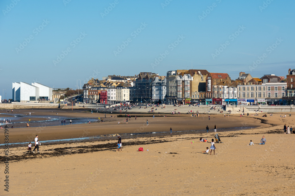 Margate beach during summer holiday, with The Turner contemporary in the background with blue sky.