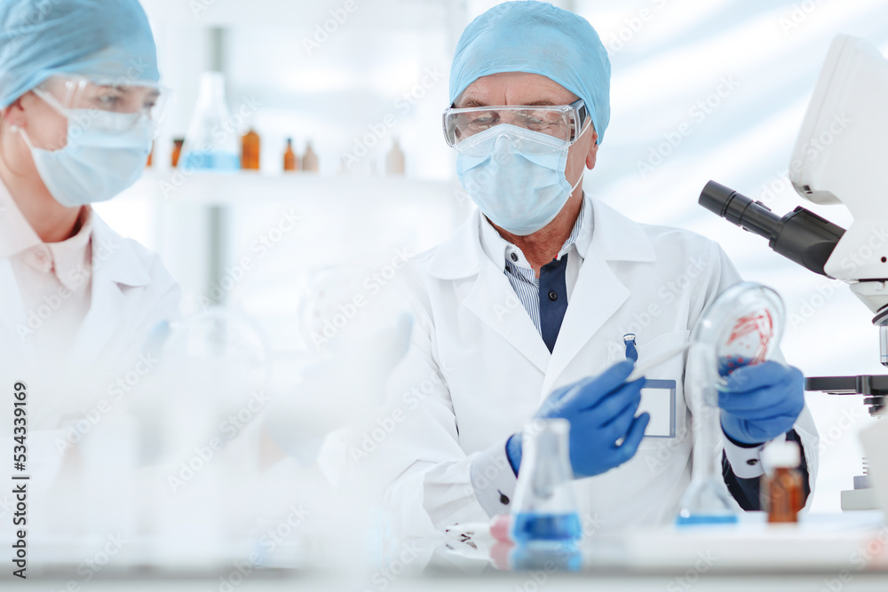 close up. microbiologists discussing the results of a scientific experiment. close up. microbiologists discussing the results of a scientific experiment.