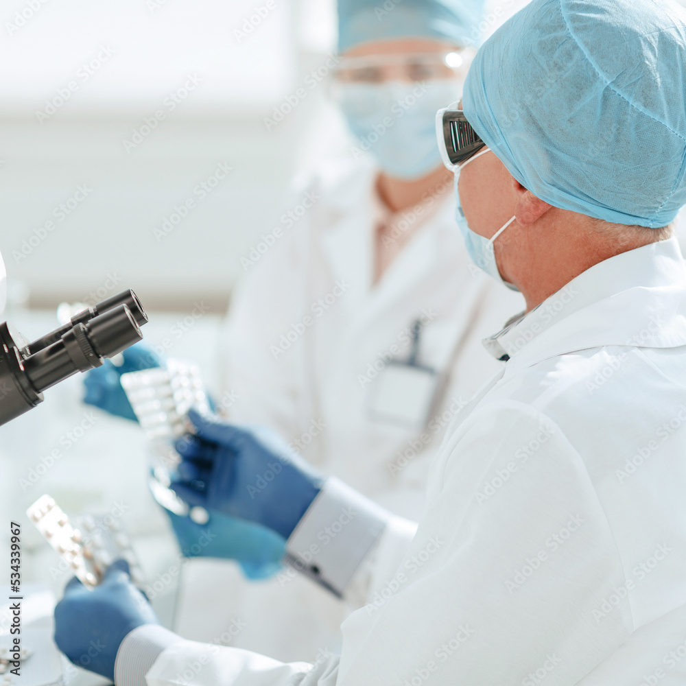 close up. scientists are testing samples of new drugs . close up. scientists are testing samples of new drugs .